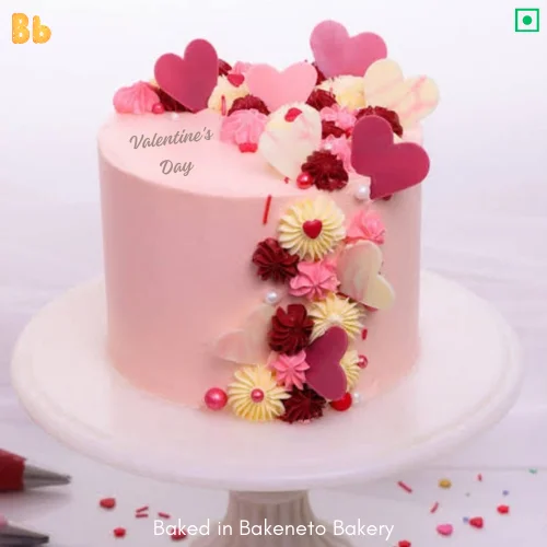 A Pink color tall shaped cake, loaded with lost of heart shaped chocolate. A perfect cake for Valentines Day Theme Cake. You can Order cakes online in Noida, Indirapuram and Gaur City Noida Extension by bakeneto.com